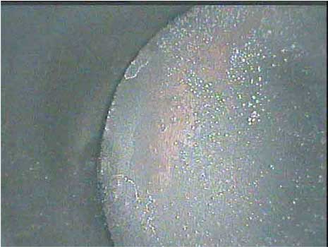 Image of a piston dome in good condition taken by a VJ-Advance video borescope during an automotive engine inspection