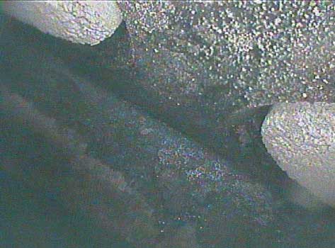 Image of buildup on a cylinder head and valves taken by a VJ-Advance video borescope during a Waukeshaw 7042 Inspection