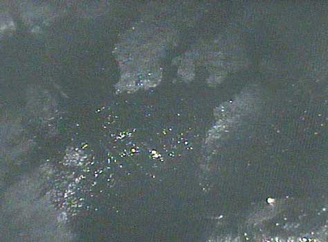 Image of a coolant rupture that led to coolant seeping into the combustion chamber taken by a VJ-Advance video borescope during a Waukeshaw 7042 Inspection