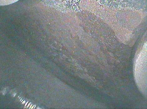 Image of carbon deposits on the cylinder head taken by a VJ-Advance video borescope during a Waukeshaw 7042 Inspection