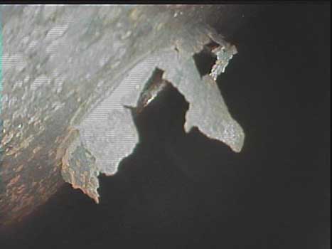 Helicopter airframe corrosion and rupture seen during an inspection as shown through a VJ-Advance video borescope