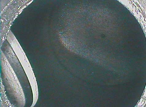 Piston dome from spark plug access hole as seen through a VJ-Advance video borescope